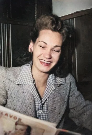 Mom looking super glamorous, laughing at a magazine in a booth in one of the many restaurants she and Dad frequented in the day - c.1955