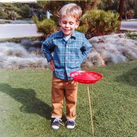 Carefully eyeing a spinning red UFO atop a stick in the front yard, 15472 Huston St - 1969