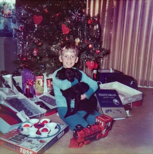 With our tiny Poodle-and-Papillon mix Baby Doll, Christmas morning in front of the tree - Dec 24 1971