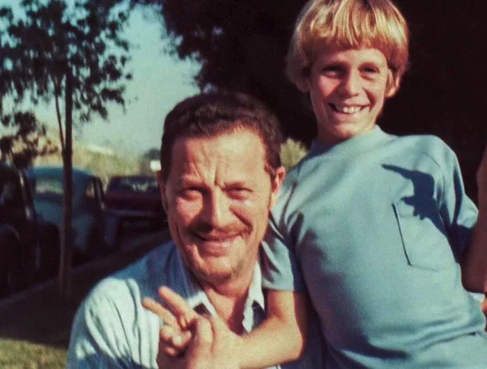 Dad and me (flashing peace signs again) on the sidewalk in front of Aunt Sheila's house on Ranchito, Van Nuys - Thanksgiving 1973.